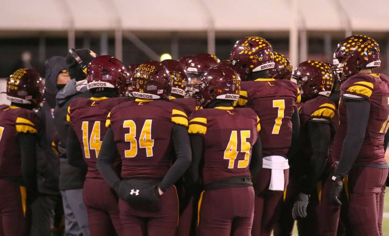 Members of the Montini Catholic football team gather during a timeout against Monticello during the Class 3A State football championship on Friday, Nov. 29, 2024 at Hancock Stadium in Normal.