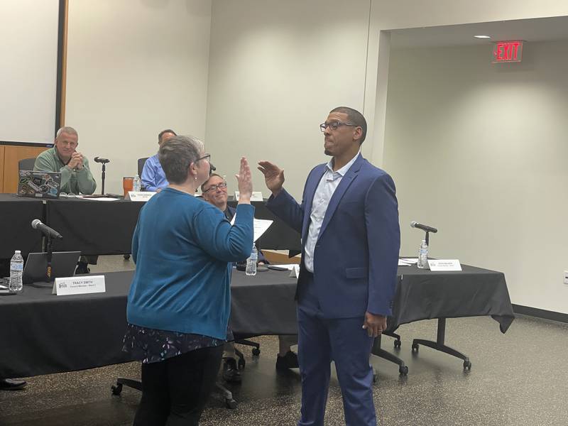 Seventh Ward Ald. John Walker (right) takes the oath of office at the May 8, 2023 meeting of the DeKalb City Council.