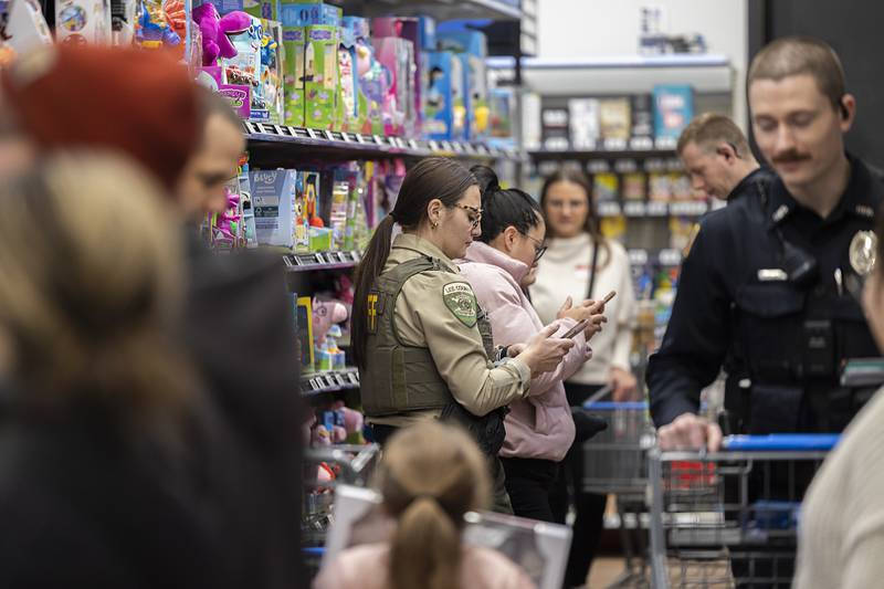 Lee County Deputy Alyscia Settles adds up her shopper’s cart Saturday, Dec. 13, 2025, in Dixon for the annual Shop with a Cop.