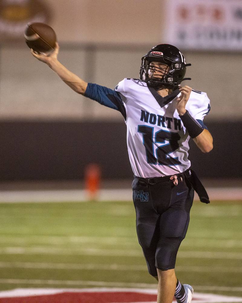 Woodstock North's quarterback Landan Creighton passes to a receiver downfield in a game against the LaSalle-Peru Cavaliers at Howard Fellows Stadium on September 8, 2023.