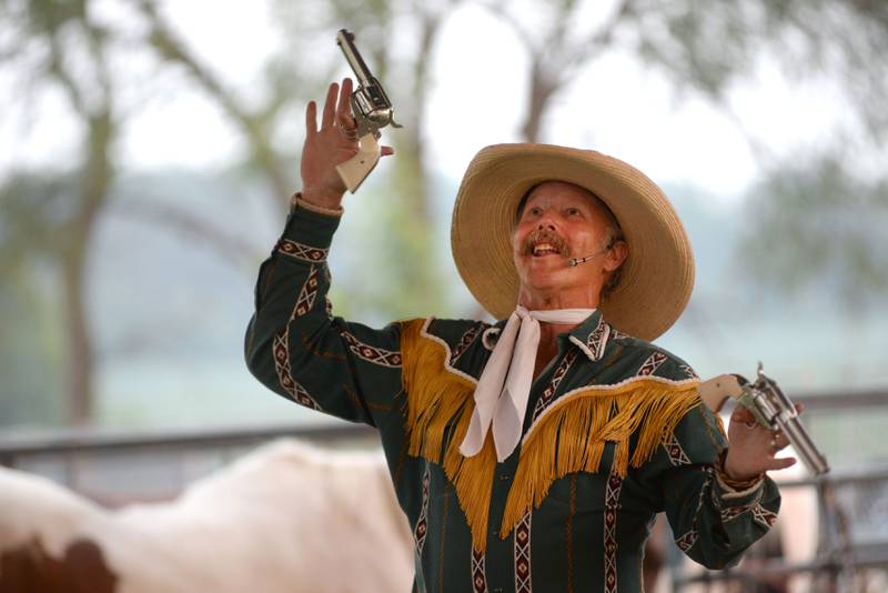 The Rhinestone Roper performs gun tricks during a performance at the Ogle County Fair in Oregon on Thursday, July 31, 2025.