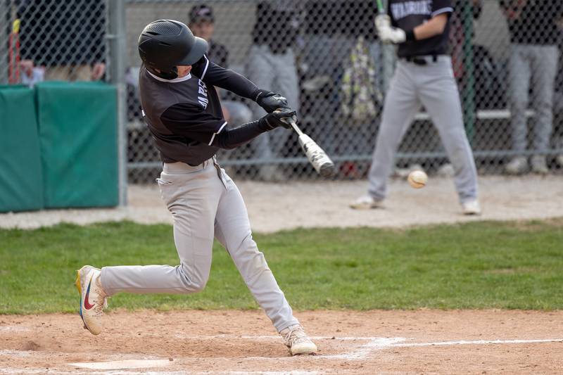 Connor Dodge (11) of Streator/Woodland hits ball on Thursday, April 10, 2025 at St. Bede High School in Peru.