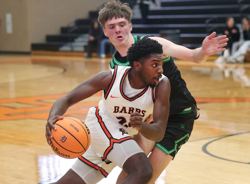 DeKalb's Myles Newman tries to drive by Rock Falls' Max Burns during their game Tuesday, Dec. 2, 2025, at DeKalb High School.