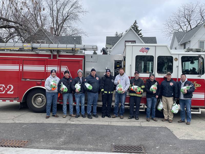 Members of DeKalb Firefighters Local 1236  are seen Friday, Nov. 18, 2022 holding turkeys in front of fire engine No. 2 to donate to The Salvation Army for WLBK radio station's annual Let's Talk Turkey drive, providing holiday meals for area families in need.