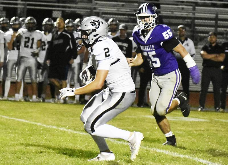 Kaneland’s Dylan Sanagustin runs with the football as Rochelle’s Kaiden Morris gives chase during Friday’s Interstate 8 matchup.