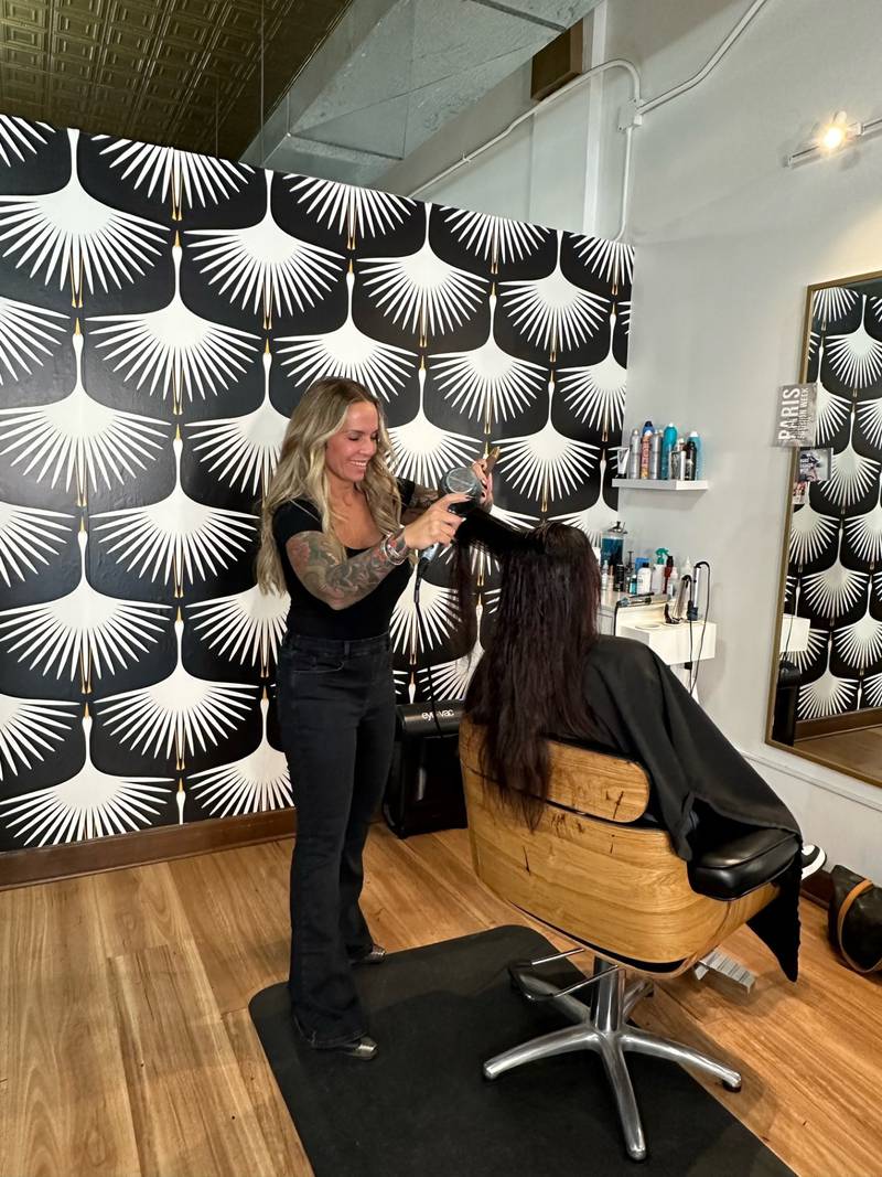 Adrianne Henkel works on a client at Maven Salon in La Salle.
