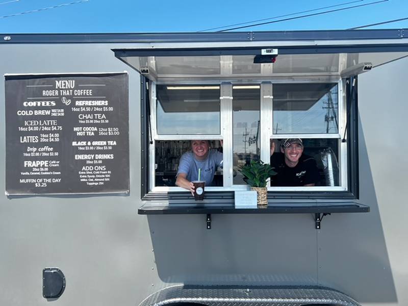 Sharyl and Miles Rogers of Sterling peek through the windows of their new Roger That Coffee trailer. They serve a wide range of caffeinated drinks, including drip and cold brew coffee, lattes, frappes, chai tea, refreshers and energy drinks.