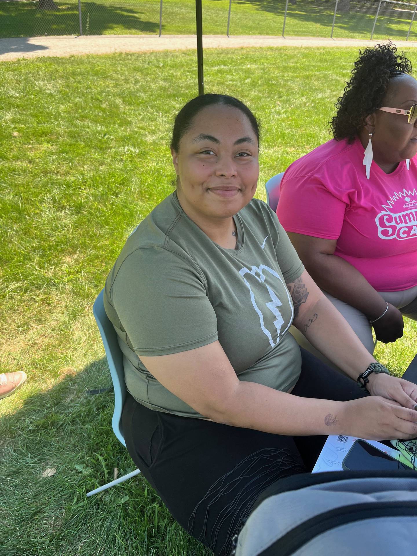 Jayed Gamble, parent of a sixth grade student at Gompers Junior High School in Joliet, volunteers at a welcome tent during the Joliet Park District's back-to-school event at Nowell Park. on Saturday, Aug. 9, 2025.