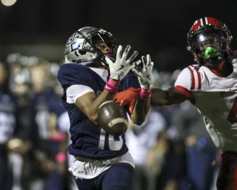 Yorkville's Jayden Ruth (4) defends a bomb to Oswego East's Donavin Eason (16) during football game between Yorkville at Oswego East Friday, Oct 10, 2025 in Oswego.