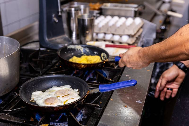 The kitchen staff cooks up multiple styles of eggs at Rosemary Cafe in Joliet on Feb. 2, 2025.
