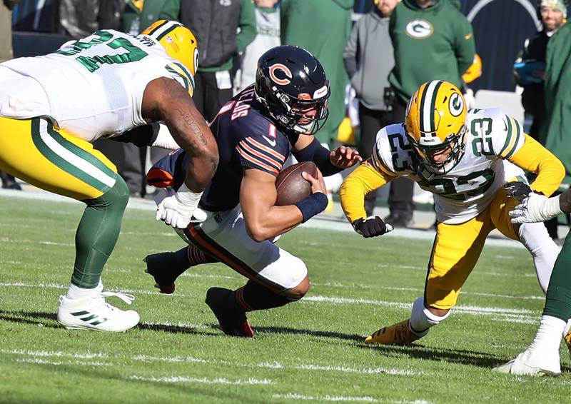 Chicago Bears quarterback Justin Fields dives for extra yardage between Green Bay Packers defensive tackle Kenny Clark and cornerback Jaire Alexander during their game Sunday, Dec. 4, 2022, at Soldier Field in Chicago.