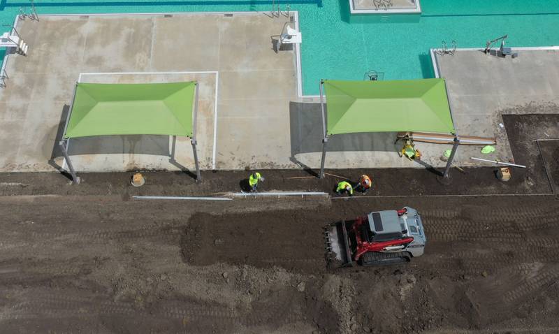 Workers move dirt to landscape behind Riordan Pool on Tuesday, June 13, 2023 in Ottawa. The pool will open June 19 to the public. The construction of the 6.7 million dollar pool began in September of 2022. The facility includes a 9,700 square foot pool, complete with a zero foot entry, six 70-foot competition lanes and three diving stands, plus a 5,700 square foot building containing private family changing rooms, locker rooms, showers, restrooms and offices.
There will be a shelter with picnic tables, vending machines and tables for umbrellas.