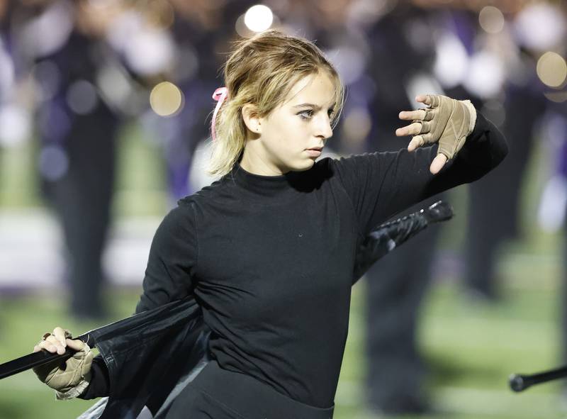 A Downers Grove North color guard performs during halftime at the varsity football game between Downers Grove North and Lyons Township on Friday, Oct. 11, 2024 in Downers Grove.