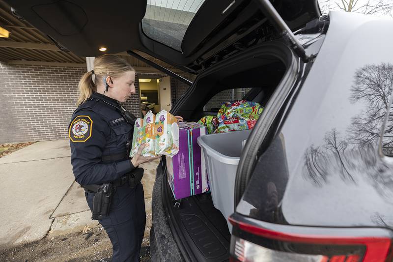 RFPD officer Kari Reynolds loads up a squad car with items for Operation Santa Monday, Dec. 23, 2024. Gifts, food and household items were all part of the donations.
