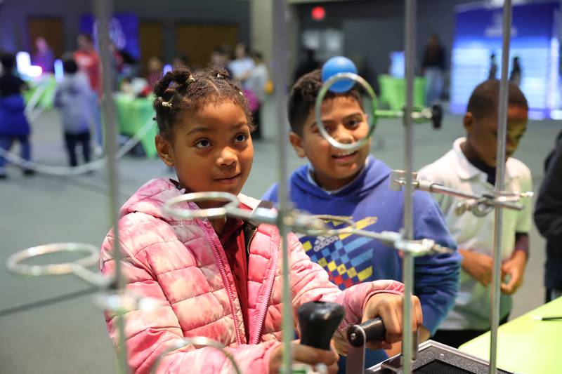 Kankakee third-grader Khelanee Smith-Gullens manipulates a ball through a hoop as she learns about the Coandă effect during the Impossible Science event at the Kankakee First Church of the Nazarene on May 5, 2026.