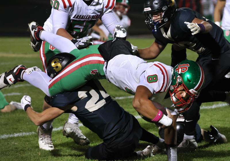 La Salle-Peru's Marion Persich gets upended by Sycamore's Crewe Bartelt during their game Friday, Oct. 10, 2025, at Sycamore High School.