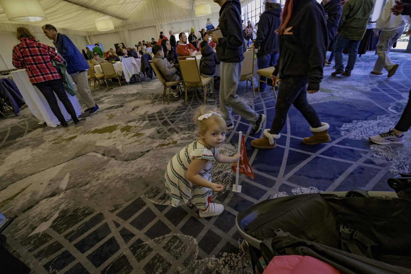 A young guest plants her Jeep flag during the 2024 Jeeps on the Run Toys for Tots Run after-party in Lincolnshire.