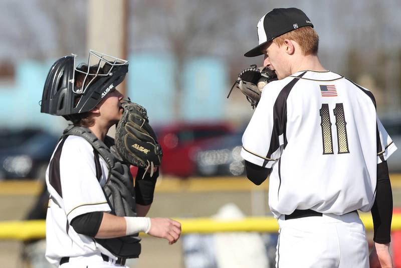 Sycamore's Kyle Hartmann comes out to talk to pitcher Teague Hallahan during their game against Harlem Monday, March 27, 2023, at the Sycamore Community Park.