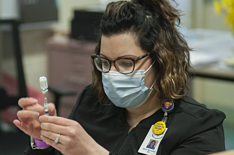 Sarah McCaskey, RN for the Carroll County Health Department, fills syringes with COVID vaccine Wednesday afternoon at a mass vaccination site in Chadwick.