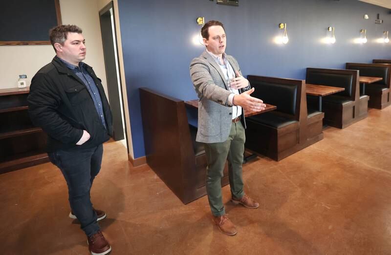 The Grove restaurant and bar owners Jason Engstrom (left) and Sam Patterson talk about the seating area Thursday, March 23, 2023, during a tour of the new eatery in DeKalb. They plan to open their doors upon completion within the next few weeks.