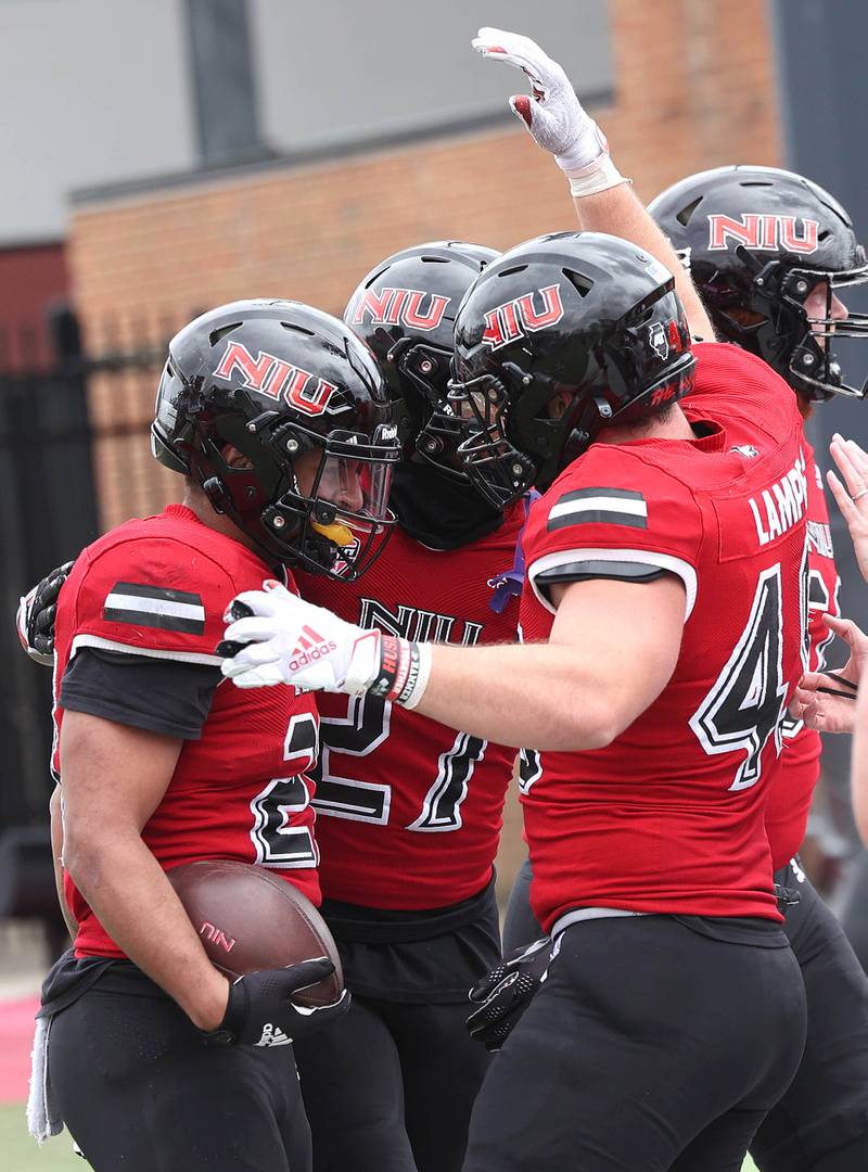 Northern Illinois running back Gavin Williams (left) is congratulated by teammates after scoring a touchdown during the Spring Showcase Saturday, April 22, 2023, at Huskie Stadium at NIU in DeKalb.