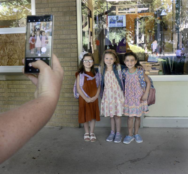 Friends and now classmates Lyla Buckingham, Brinlee Culjan and Ariana Veldez pose for a photo Wednesday, Aug. 31, 2022, outside McKinley School in Ottawa as they start their first day of kindergarten.