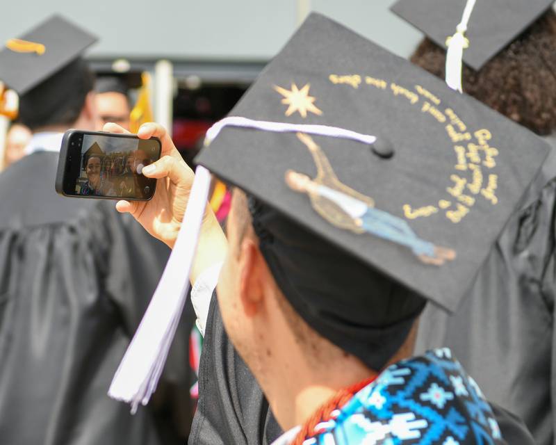 Northern Illinois University graduate Wes Bulatov of Ukraine takes a selfie after the graduation ceremony on Saturday May 9, 2026, held at the Convocation Center in DeKalb.