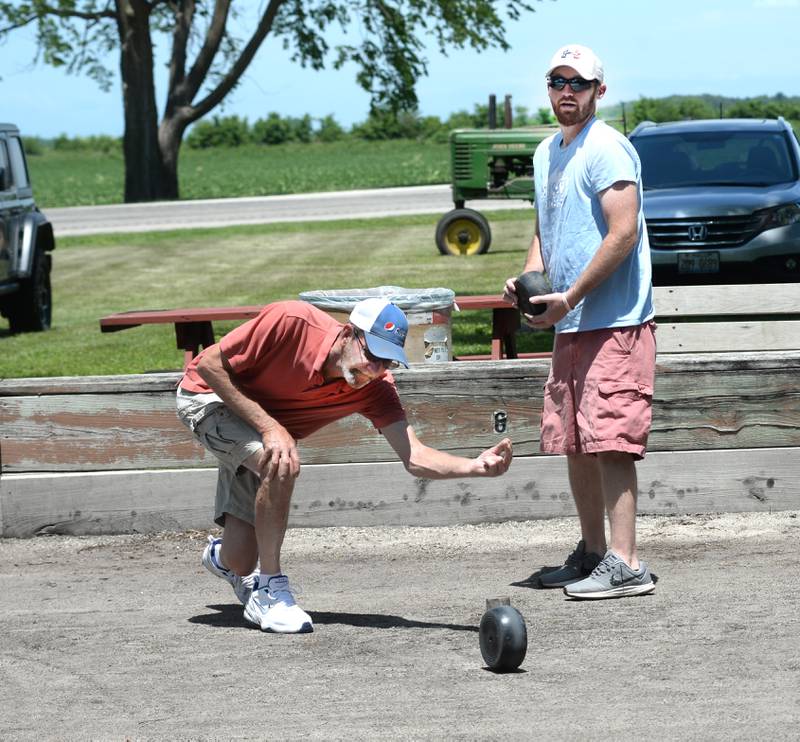 Carl Suhr releases the bolle as Glen Ryan Hoostens watches during the Rolle Bolle tournament at Hooppole Fun Day on Saturday, June 28, 2025 in Hooppole.