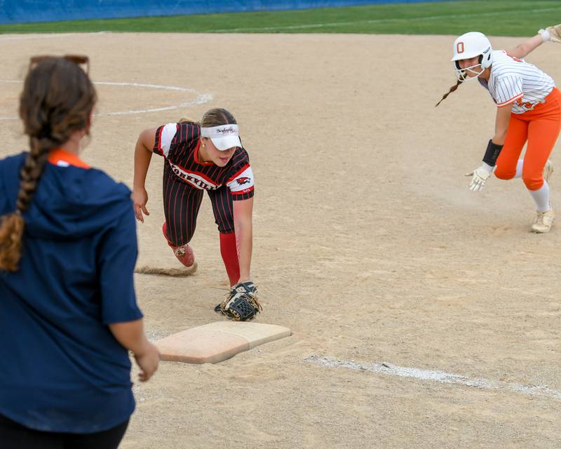 Yorkville's Ellie Fox, center, tags the base after catching the ball for a double play as Oswego's Madelyne Lohrman (3) was too far off the bag after the catch during the sectional semifinal game on Tuesday June 3, 2025, held at Oswego High School.