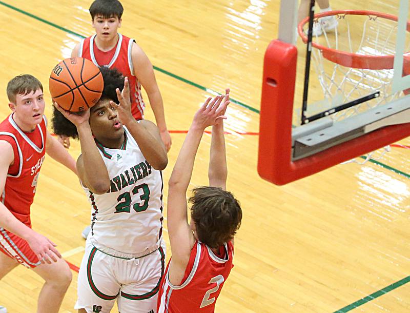 L-P's Maalik Madgrigal drives to the basket as Streator's Matt Williamson defends on Thursday, Jan. 28, 2023 at L-P High School.