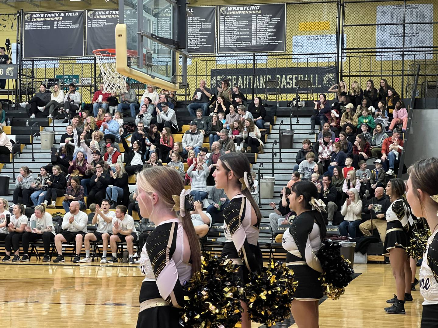 People in the bleachers cheer for a play during the Heroes on Hardwood event in Sycamore High School on Dec. 19, 2023.