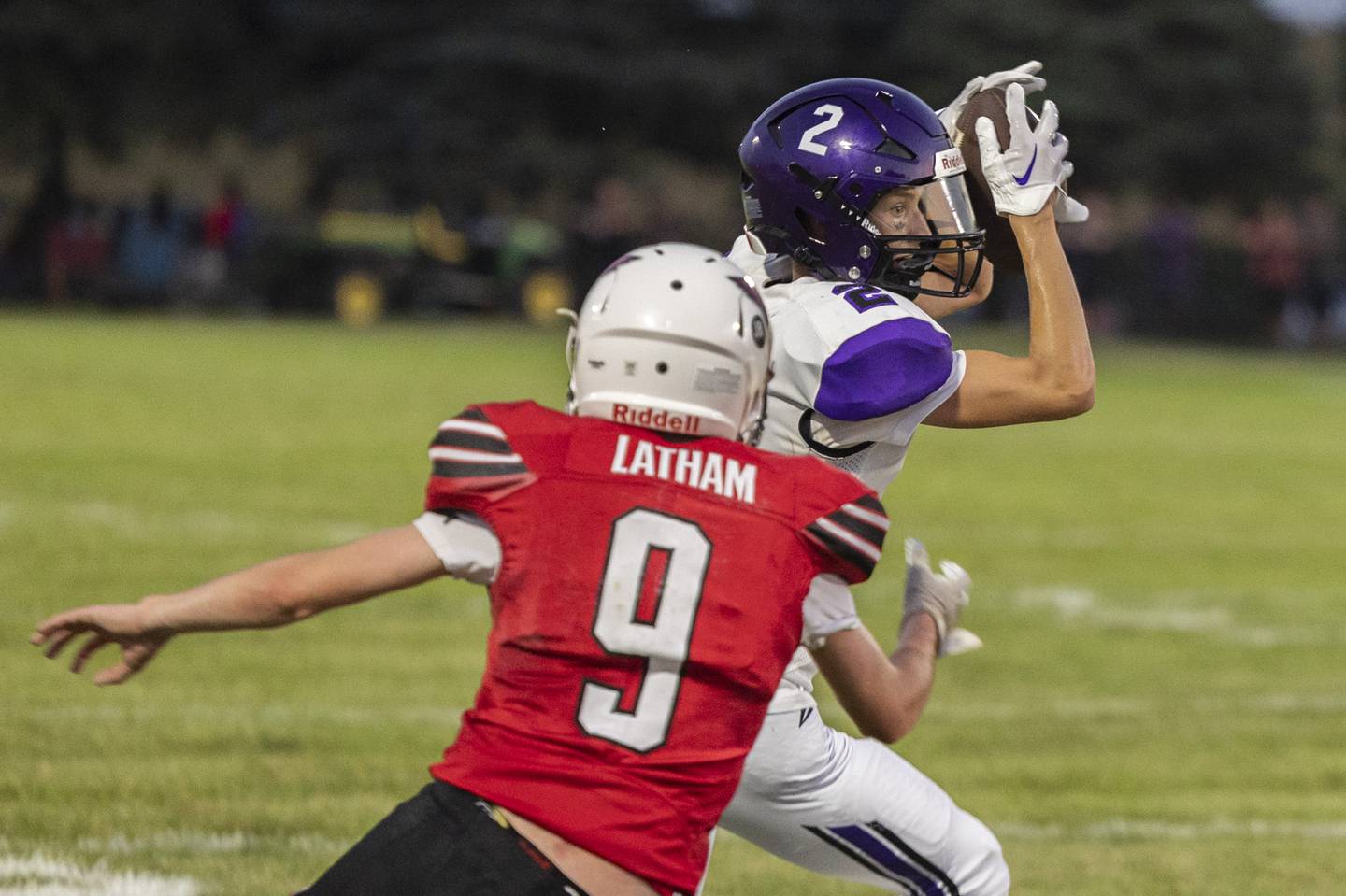 Dixon’s Cullen Shaner hauls in a pass in front of Stillman Valley’s Noah Latham Friday, August 25, 2023.