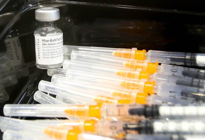 Syringes filled with the COVID-19 vaccine wait to be administered May 20, 2021 during a clinic at the Convocation Center at Northern Illinois University in DeKalb.