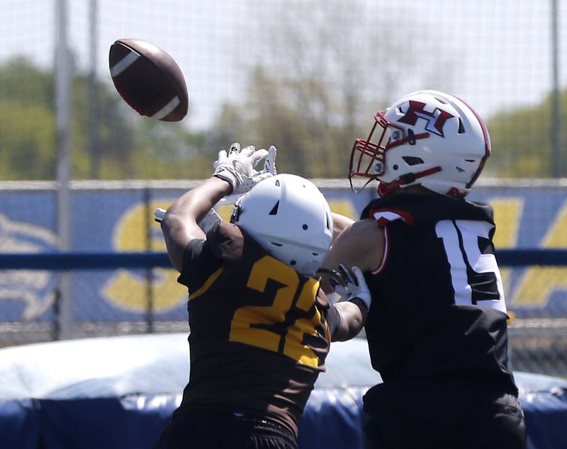 Jacobs' Cooper Gulgren tries to knock the ball away from Huntley's Matthew Schroeder at the Northern Burbs Football Showcase on Monday, May 4, 2026, at Johnsburg High School. Over 165 players from 15 teams demonstrated their football skills to over 60 college coaches.
