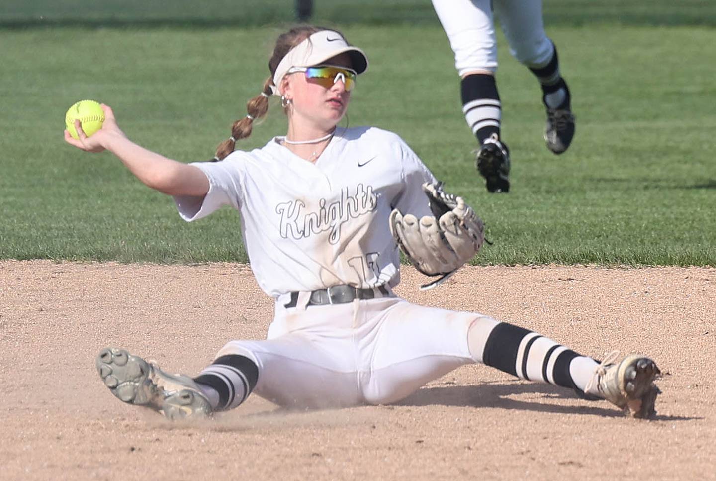 Kaneland's Katie Congoran is able to throw out a Sycamore runner after falling down making a play Friday, April 28, 2023, during their game at Sycamore High School.
