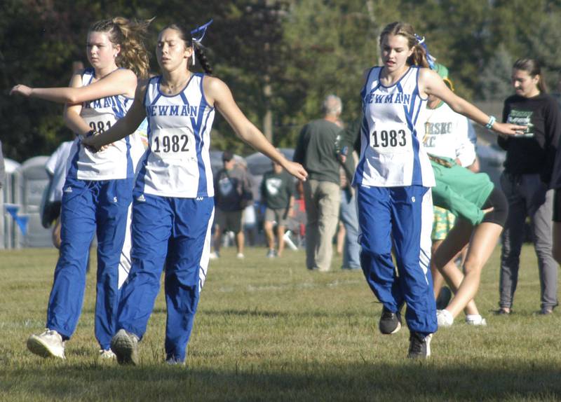 CC teammates from Newman loosen up before the race..Local High School teams gathered at Hoover Park in Sterling for the Rock River Run, held on Saturday, September 27, 2025.