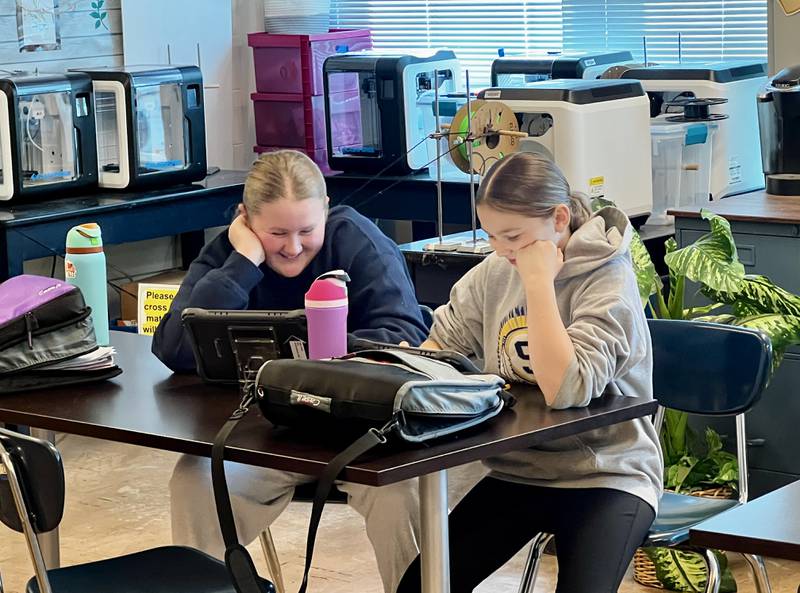 Sterling Challand Middle School students Sophia Gabel and Karle Crandall work on their projects in STEM class.
