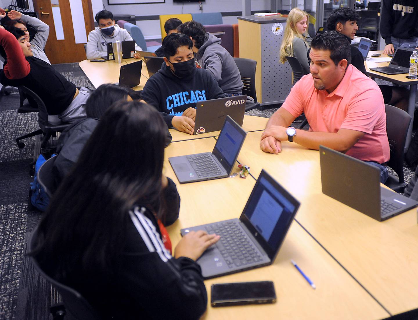 Harvard High School teacher Nick Valenziano talks with students Wednesday, April 6, 2022, as he teaches about different types of laws in a business law class.