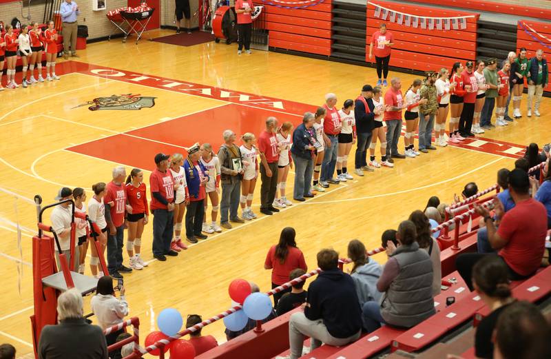 Ottawa and L-P volleyball players stand with Veteran family members and friends during the "Volley for Vets" night on Thursday, Oct. 17, 2024 in Kingman Gym at Ottawa High School.
