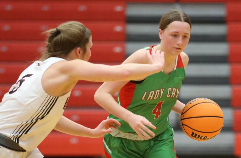 L-P's Alexus Hines dribbles around Metamora's Mackinzi Beccue during the Ottawa Girls Holiday Tournament on Monday, Dec. 16, 2024 in Kingman Gym at Ottawa High School.