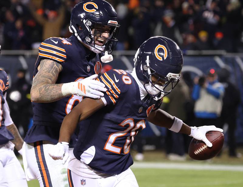 Chicago Bears wide receiver Jahdae Walker (right) celebrates with teammate Colston Loveland after catching a touchdown pass during their game against the Detroit Lions Sunday, Jan. 4, 2026, at Soldier Field in Chicago.