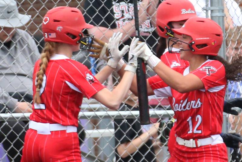 Bradley-Bourbonnais Alayna Sykes (right) hi-fives teammate Bristol Schriefer during the Class 4A Supersectional game on Friday, June 6, 2025 at Monticello High School.