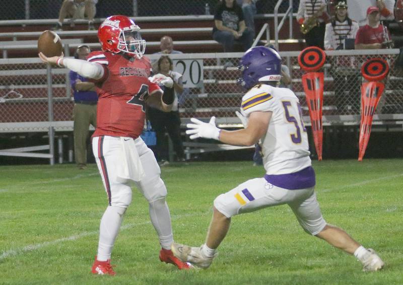 Hall's Houston Yanek looks to throw as Sherrard's Sam Steckel puts pressure on him on Friday, Sept. 19, 2025 at Richard Nesti Stadium.