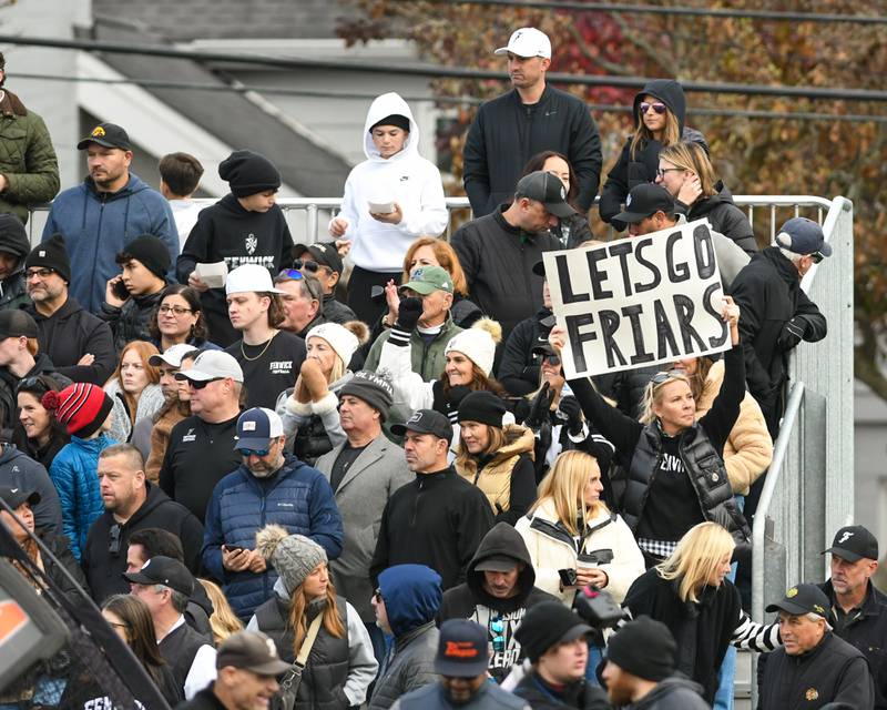 A Fenwick fan shows her support by holding up a “Lets Go Friars” during the 6A semifinals game on Saturday Nov. 22, 2025, held at Nazareth Academy High School in La Grange Park.
