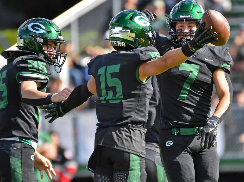 Glenbard West’s Bryce Ellens (15) celebrates with teammates Reese Dehesus (85) and Luke Brennan (7) after grabbing a onside kick during a game against Joliet Catholic on September 6, 2025 at Glenbard West High School in Glen Ellyn.