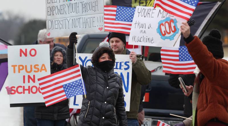 A gathering protests Thursday, Feb. 5, 2026, in front of Genoa-Kingston High School. The group is protesting the “History Rocks” assembly which is part of a nationwide campaign by the U.S Department of Education tied to the nation’s 250th anniversary and organized by the high school’s Turning Point USA, Club America chapter, a nonprofit founded in 2012 by the late Charlie Kirk.