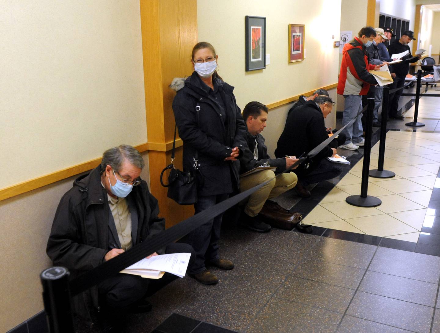 McHenry County Clerk candidate Andrew Georgi Jr. checks over his paperwork as he waits to file his candidate forms the morning of Monday, March, 7, 2022, at the McHenry County Clerk's Office in Woodstock. Monday was the first day for candidates to file ahead of the June primaries. This election season includes all McHenry County Board seats, the clerk, sheriff and regional superintendent of education. The candidates were trying to get the first slot on the ballot by filling at 8 a.m. When more than one candidate applies at a time, a lottery is held.