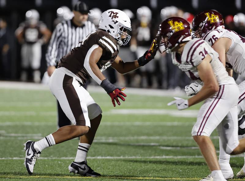 Mt. Carmel's Braeden Jones (99) rushes the Loyola offense during the varsity football game between Loyola Academy and Mt. Carmel high school on Friday, Oct. 25, 2024 in Chicago.