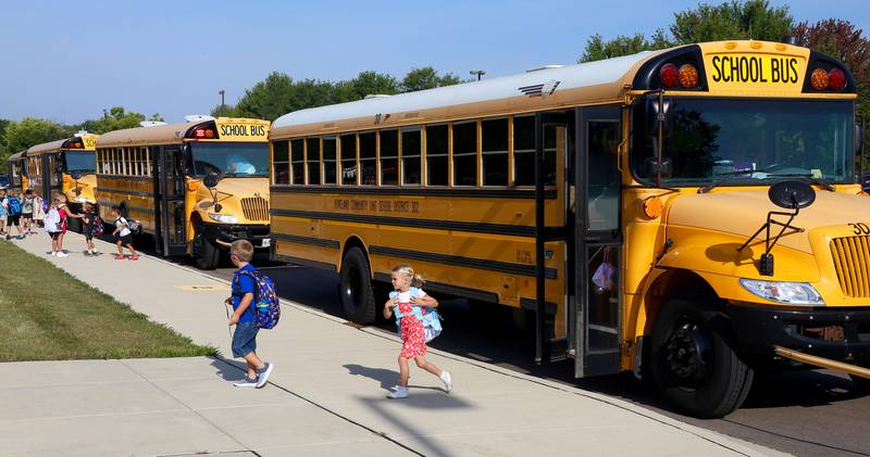 Students exit school buses on the first day of school at Kaneland John Stewart Elementary in Elburn on Wednesday, Aug. 14, 2024.