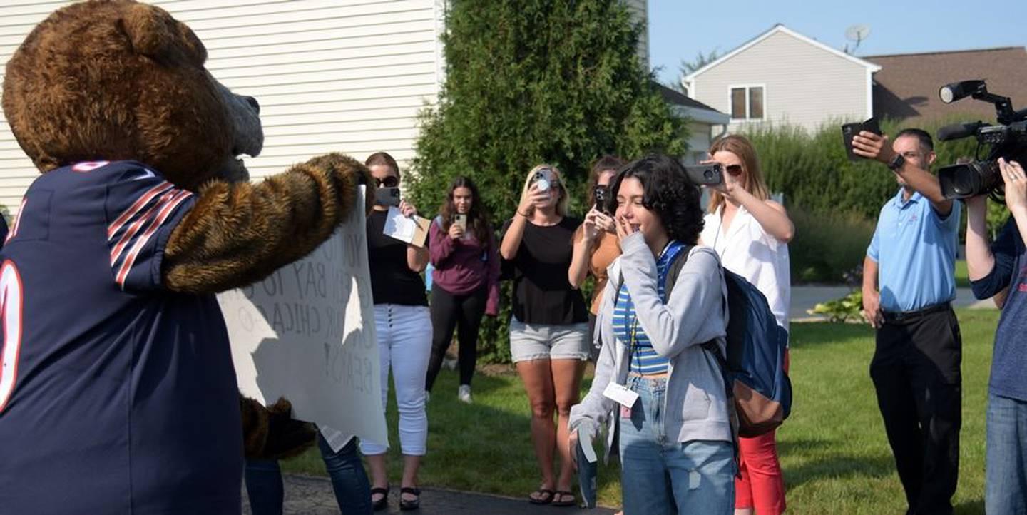 Kaylah Gonzalez of South Elgin reads cue cards held by Chicago Bears mascot Staley Da Bear asking the 14-year-old cancer patient if she would like to go to the Bears game in Green Bay, Wisconsin.